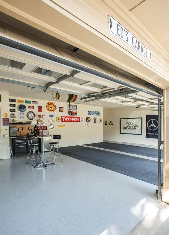 Custom garage work area, with workbench and car-themed decor, Dallas TX by Nicole Arnold Interiors