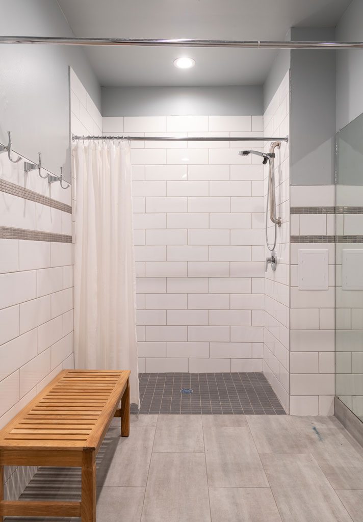 Shower, white subway tile and stainless steel mosaic tile, office interior design by NIcole Arnold commercial interior designer, Dallas